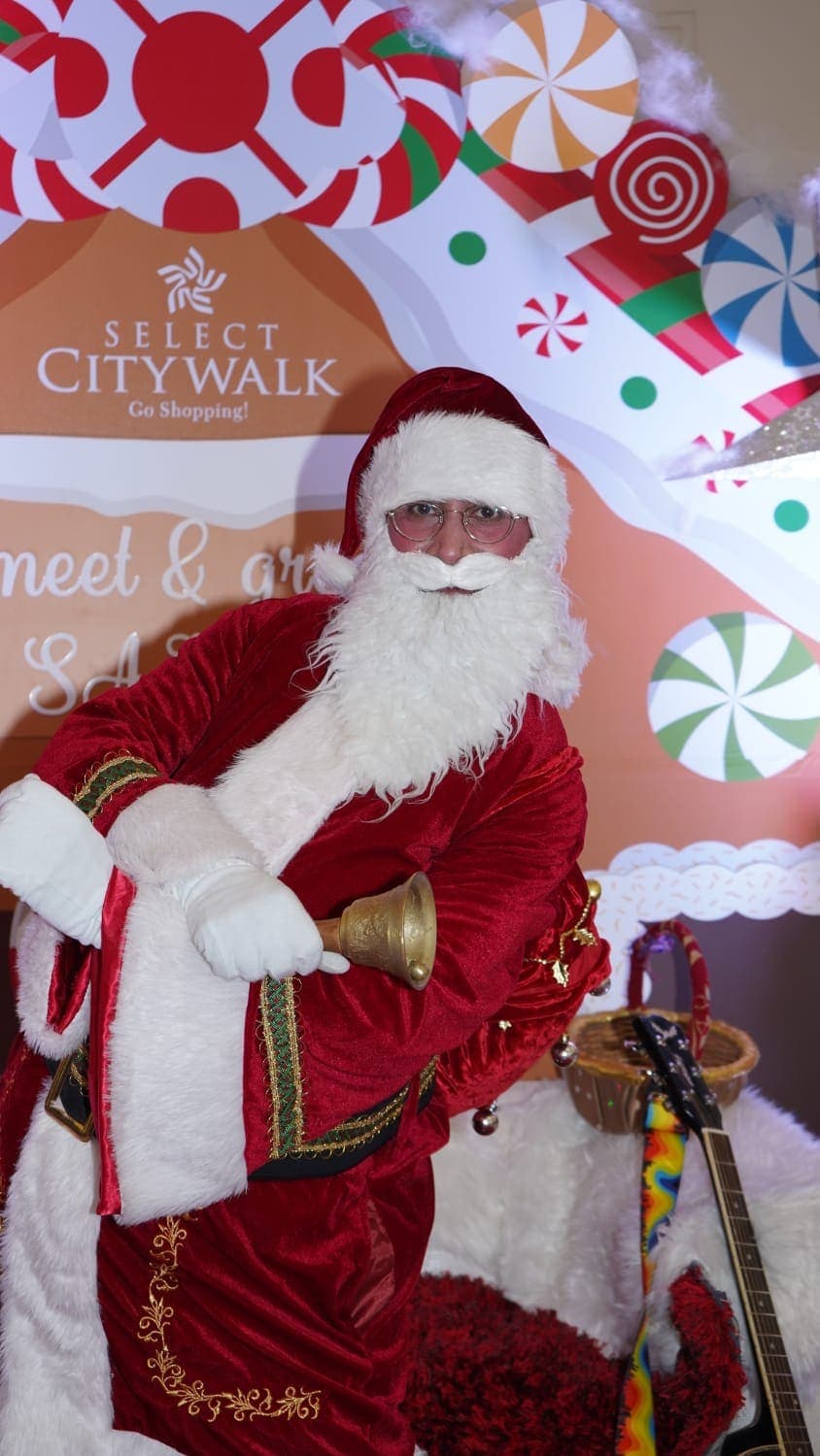 Warm indoor celebration, Santa with guests
