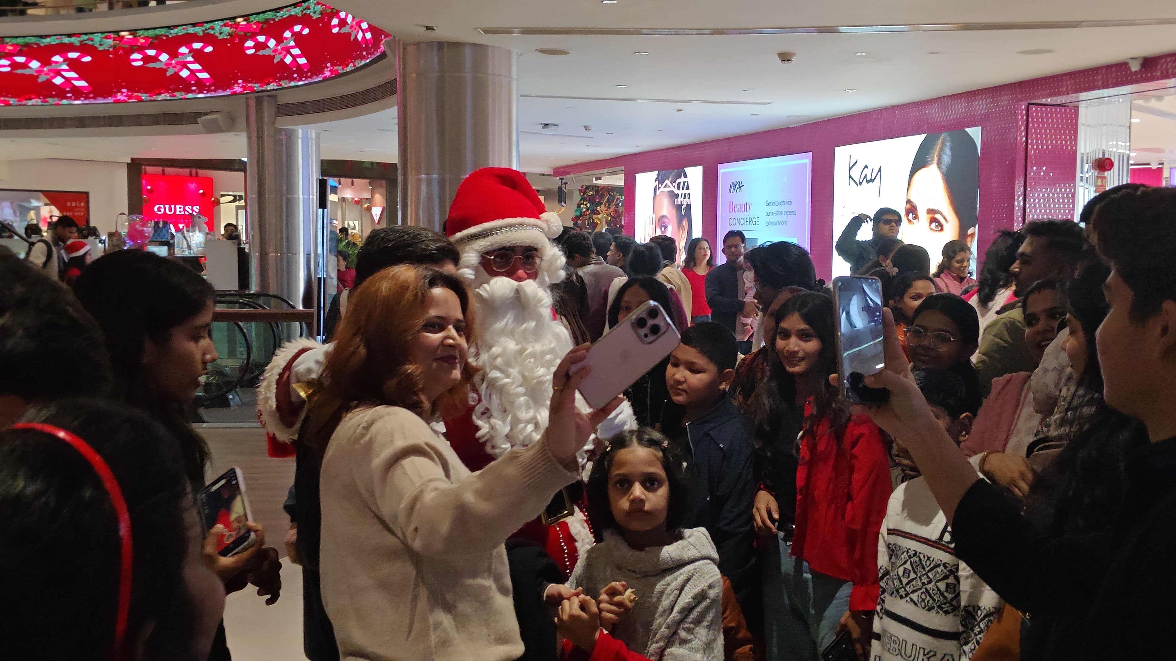 A long queue of families waiting to meet Santa Claus on a December evening