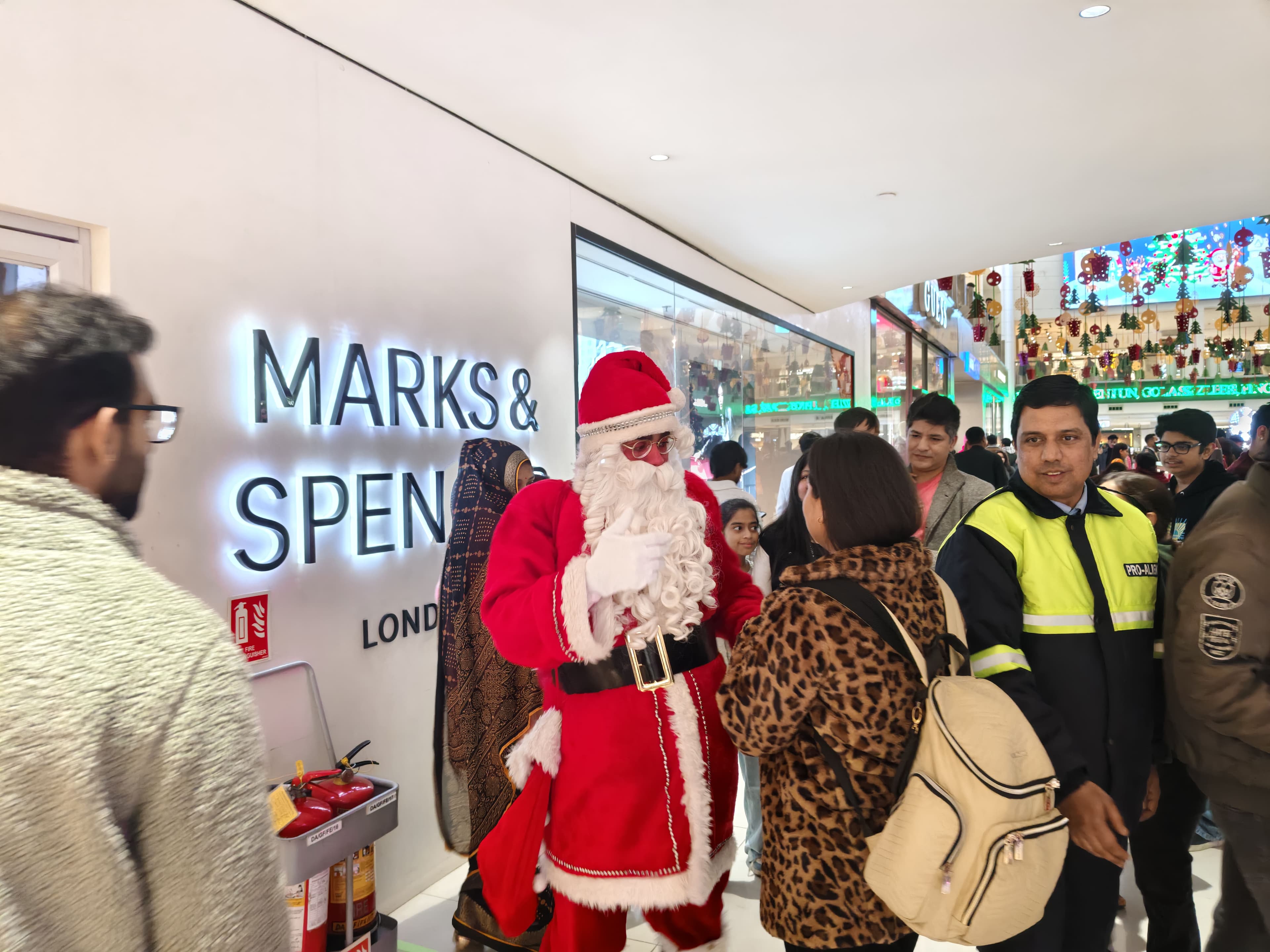 Mall event, Santa with families amid branded retail